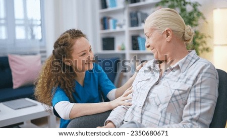A smiling female social worker visits a senior lady at her home to provide support and care