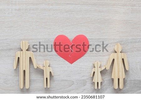 Divorce lawyer Or Attorney, Broken red heart with husband and wife splitting children on wooden background,Joint child custody and alimony concept. Royalty-Free Stock Photo #2350681107