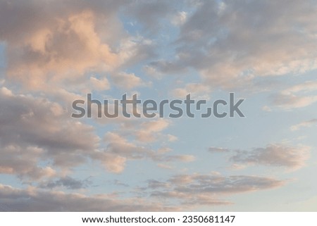 Beautiful fluffy clouds painted in bright painterly colors at sunrise. Multicolor background or wallpaper Royalty-Free Stock Photo #2350681147