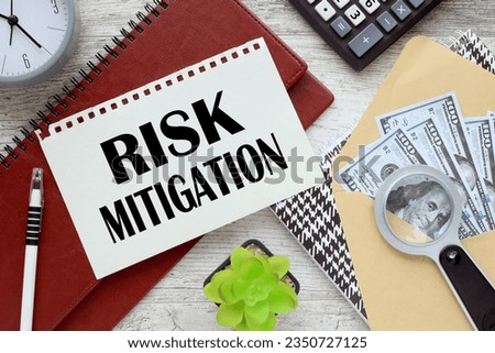 Risk mitigation office desk, banknotes of money in an envelope. words on the page