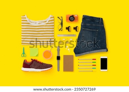 Getting ready for school flat lay, womens clothing. Back to school flat lay on yellow background