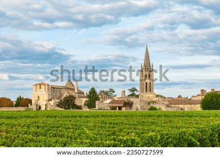 Vineyards of Saint Emilion, Bordeaux, Gironde, France. Medieval church in old town and rows of vine on a grape field. Wine industry Royalty-Free Stock Photo #2350727599