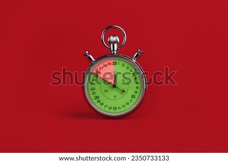 stopwatch with colorful segments on red background. Interest-free period concept