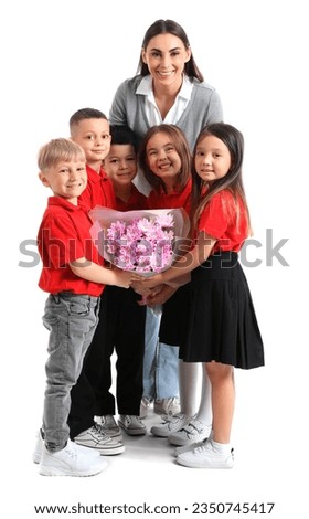 Little school children with female teacher and bouquet of flowers on white background