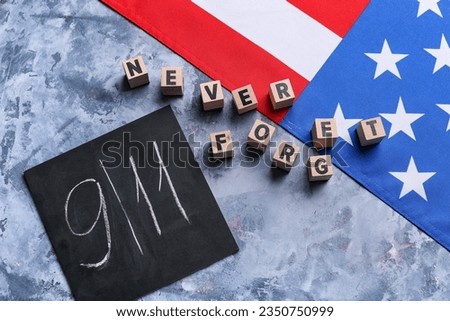 USA flag and card with date of National Day of Prayer and Remembrance for the Victims of the Terrorist Attacks on grunge blue background