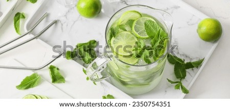 Jug of fresh mogito with lime on tray Royalty-Free Stock Photo #2350754351