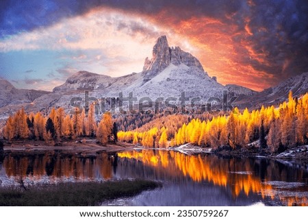 Incredible purple sunrise on Federa Lake in the Dolomite Apls. Autumn mountains landscape with Lago di Federa and bright orange larches, Cortina D'Ampezzo, South Tyrol, Dolomites, Italy Royalty-Free Stock Photo #2350759267