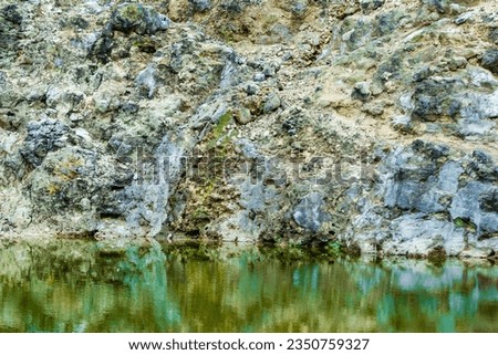 close-up of reflection of sulfur geology on the surface of the lake.