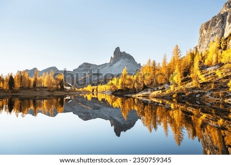 Picturesque view on Federa Lake in sunrise time. Autumn mountains landscape with Lago di Federa and bright orange larches in the Dolomite Apls, Cortina D'Ampezzo, South Tyrol, Dolomites, Italy Royalty-Free Stock Photo #2350759345