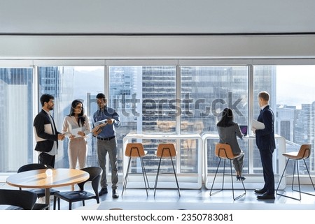 Diverse professional international team business people workers group working in corporate office space, diverse colleagues discussing work having teamwork conversations together at meeting. Royalty-Free Stock Photo #2350783081