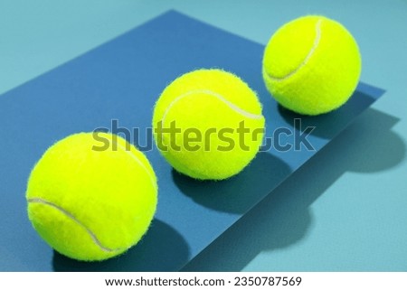 Tennis balls on two tone blue background