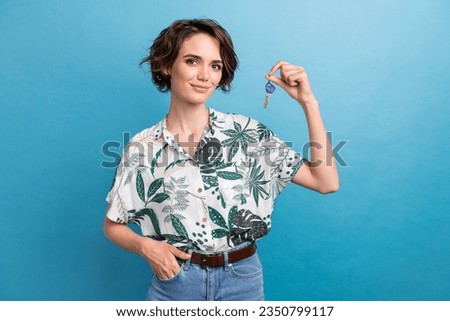 Photo of adorable pretty girl dressed colorful blouse hold keys from new apartment hand in pocket isolated on blue color background