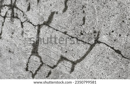 a photography of a black and white photo of a graffiti on a concrete wall, nail marks on a concrete wall with a fire hydrant.