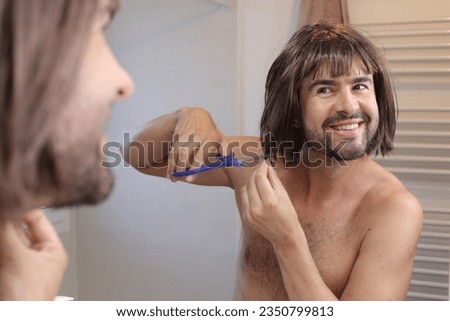 Funny man cutting his own hair Royalty-Free Stock Photo #2350799813