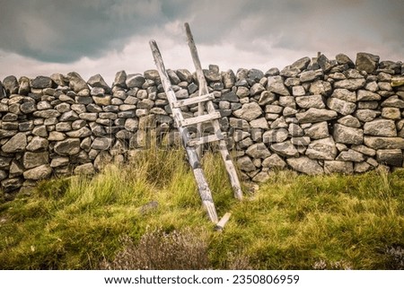 Broken dry stone wall stile above Cracoe in the Yorkshire Dales Royalty-Free Stock Photo #2350806959