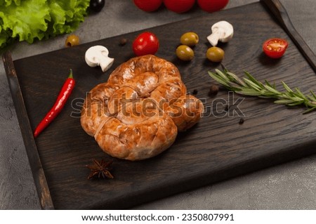 tasty handmade boiled and smoked sausage on a dark wooden background