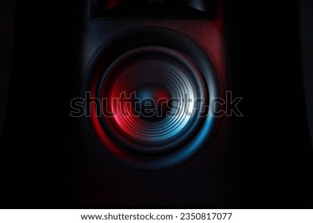 One sound speaker in neon light on black background, closeup Royalty-Free Stock Photo #2350817077