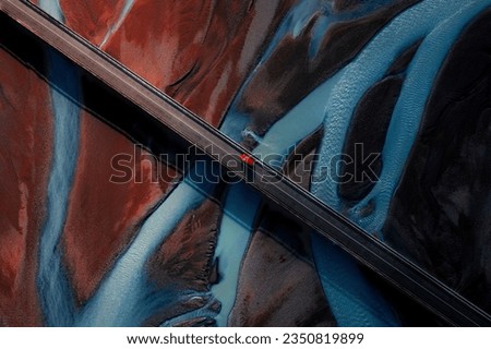 icelandic glacier river and bridge with red car view from above Royalty-Free Stock Photo #2350819899