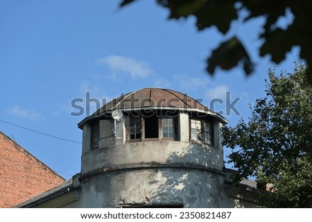 a rounded corner of an old building with a raised round turret