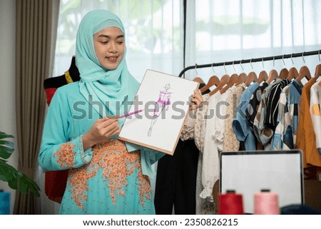 Female fashion designer showing her models.