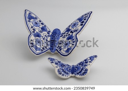 Delft blue and white porcelain butterflies Royalty-Free Stock Photo #2350839749