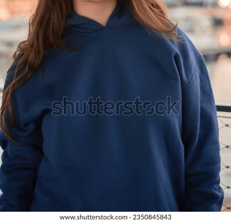 Girl wearing a basic hoodie without logo. Modern wearing brand presentation mock-up.