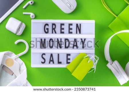 Green monday sale background with sale tags, clothes, laptop, headphones, smartphone, tablet, sale items on bright green background, flat lay top view copy space