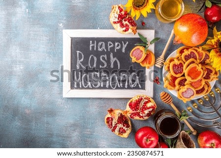 Rosh hashana jewish holiday background with red apples, honey, pomegranate, Shofar and goblet, jewish New Year holiday with traditional symbols.  Happy Rosh hashana greeting card 