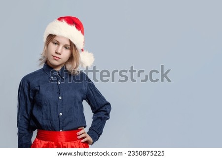 Beautiful Christmas girl portrait. Happy Xmas child Santa posing on white background