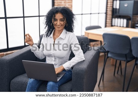 Young hispanic woman business worker having video call at office
