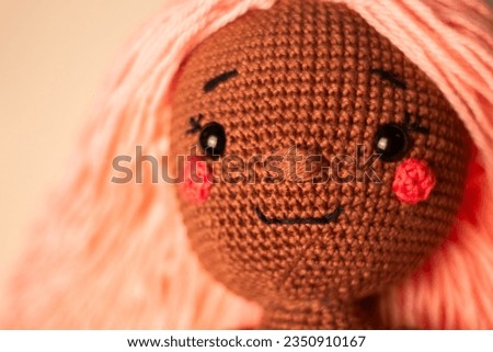 Knitted doll whith pink hair
