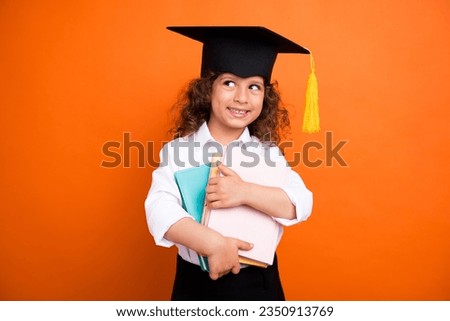 Photo of smart elementary school pupil girl hold textbooks look empty space bookshop offer isolated shine color background