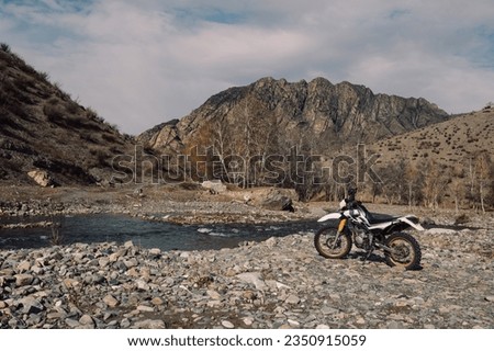 Offroad enduro motorcycle in mountains near the river