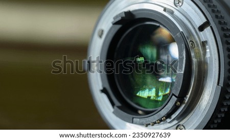 Closeup camera lens on blurred background. Selective focus.