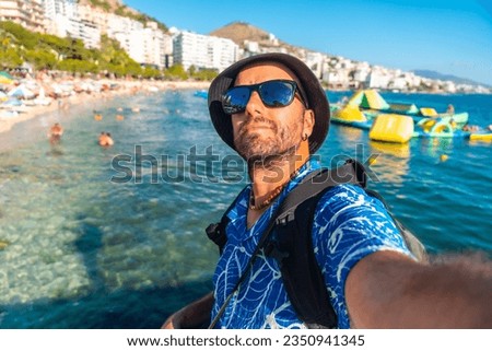 Selfie of tourist on vacation sitting by the sea at Saranda Beach on the Albanian Riviera in Sarande, Albania