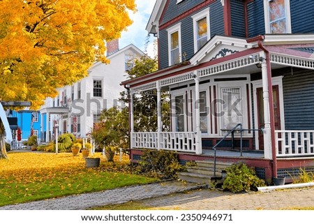 Beautiful rural houses with vibrant yellow maple tree during autumn in New England, USA Royalty-Free Stock Photo #2350946971