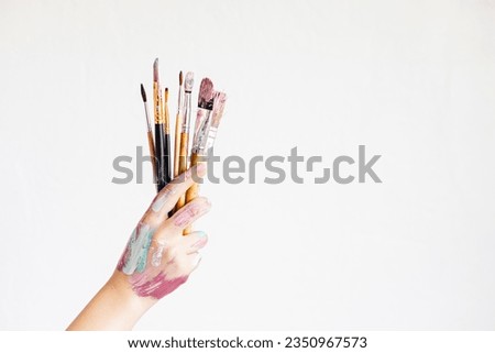 Young artist with painting brushes and colors. Craft artistic background. Recomforting, destressing creative hobby, art therapy