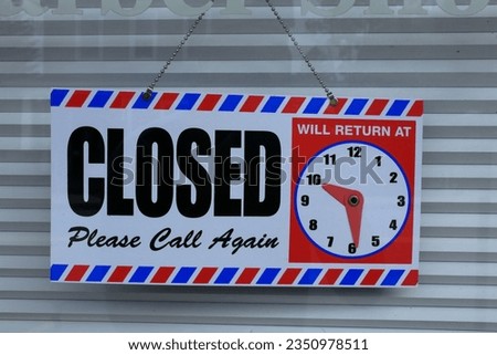 A closed sign for a barber shop
