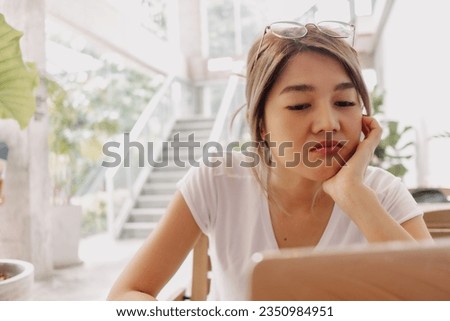 Serious and unpleasant face of asian woman work and solving problem with laptop. Royalty-Free Stock Photo #2350984951
