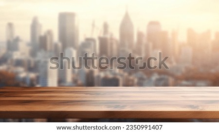 The wooden table top with blur background of modern office interior with cityscape in the morning. Exuberant image.