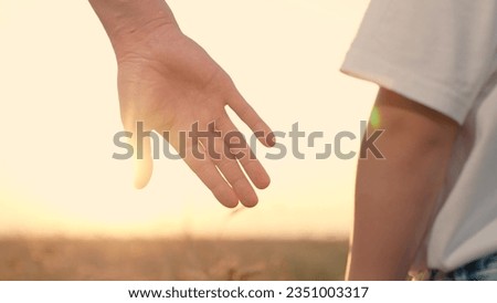 Dad holds out his hand to his son in park at sunset. Happy family, child takes his fathers hand in sun, closeup. Family trust concept. Slowmotion. Father walks with boy in nature, weekend. parent, kid Royalty-Free Stock Photo #2351003317