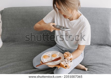 Asian woman taking photo of her easy and simple homemade breakfast.