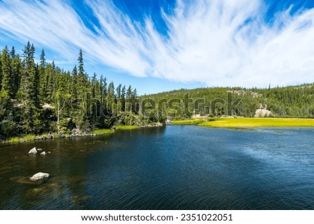 Summer afternoon at Cameron River Day Use Area in Hidden Lake Territorial Park, Northwest Territories, NT Canada Royalty-Free Stock Photo #2351022051