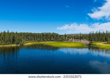 Tranquil blue lake during summer near Yellowknife, Northwest Territories, NT Canada Royalty-Free Stock Photo #2351022071