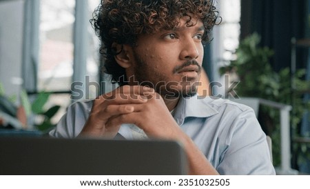 Thoughtful male guy Indian Arabian businessman office manager ceo entrepreneur employee work laptop doubtful latino man think decision solve problem thinking business project brainstorm deep thoughts Royalty-Free Stock Photo #2351032505