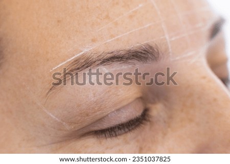 Detailed showcasing the crucial step of eyebrow mapping before permanent makeup application on a woman