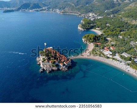 Aerial view of Sveti Stefan island and shore in a beautiful summer day, Montenegro from flying drone. Panoramic above view of Saint Stephen luxury resort. Tourism and leisure concept.Aero photography.