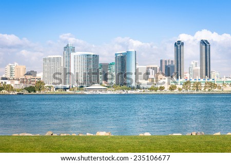 San Diego skyline and waterfront with blue water and green meadow - Skyscrapers from Coronado Island in California - United States - Travel wanderlust concept