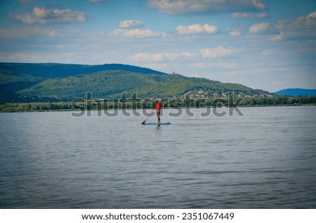 a person who likes water sports, and more precisely swimming on a board with a paddle
