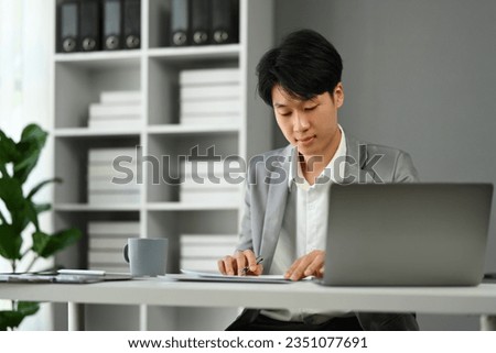 Businessman sitting at office desk working with startup project at modern office